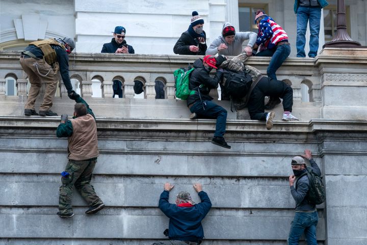 Insurrections climb the west wall of the U.S. Capitol on Jan. 6, 2021.